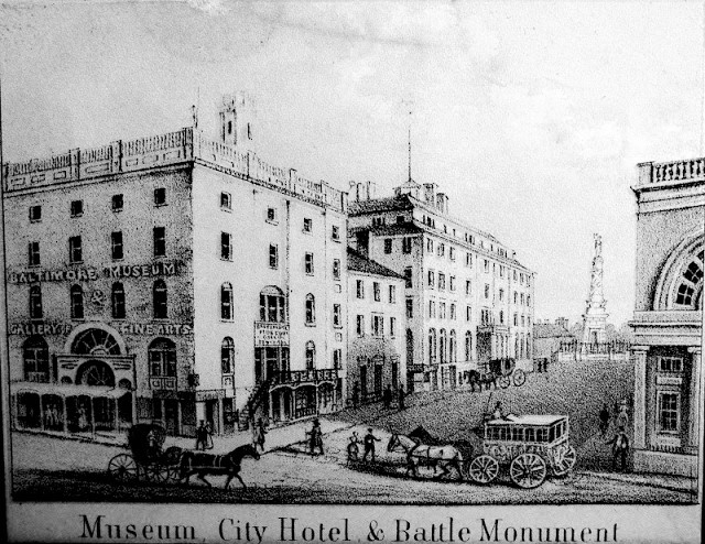 Museum City Hotel and Monument square looking north from Baltimroe Street whiter